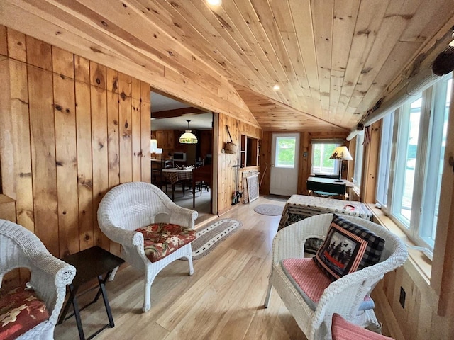 124 Spooner Rd, Pittsburg, NH 03592 - sitting room with lofted ceiling, light wood finished floors, wood walls, and wooden ceiling