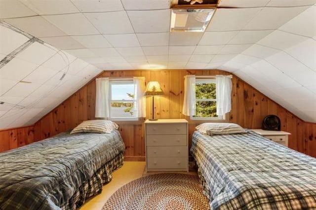 124 Spooner Rd, Pittsburg, NH 03592 - bedroom featuring multiple windows, wooden walls, and lofted ceiling