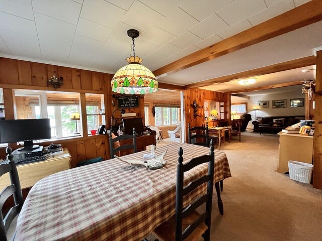 124 Spooner Rd, Pittsburg, NH 03592 - dining room featuring wooden walls, carpet, and beam ceiling