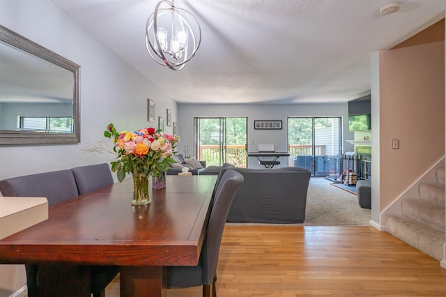 19 Village Falls Way, Merrimack, NH 03054 - dining room with a chandelier, light wood-style flooring, and stairway