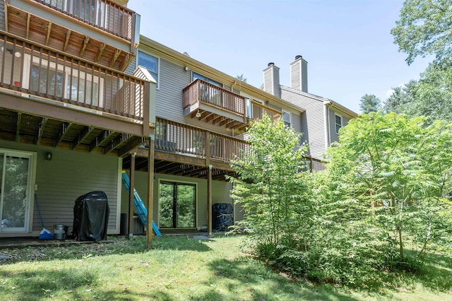 19 Village Falls Way, Merrimack, NH 03054 - rear view of house with a deck, a chimney, a yard, and a balcony