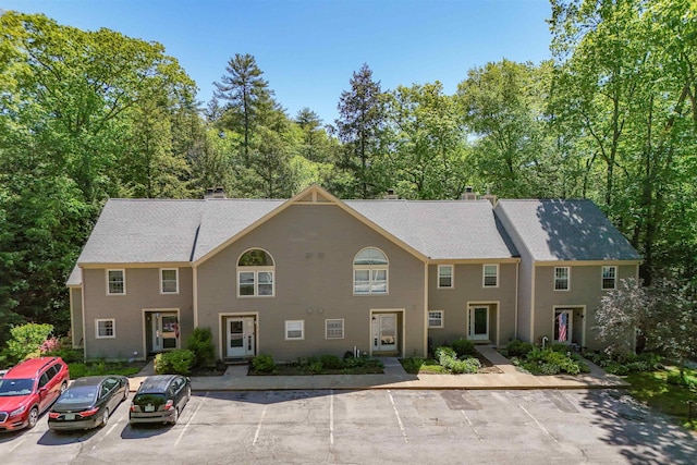 19 Village Falls Way, Merrimack, NH 03054 - view of front facade featuring a chimney and uncovered parking