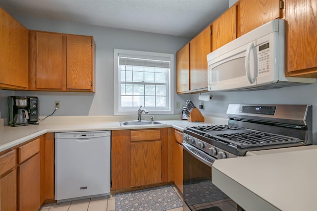 19 Village Falls Way, Merrimack, NH 03054 - kitchen with white appliances, light countertops, and brown cabinetry