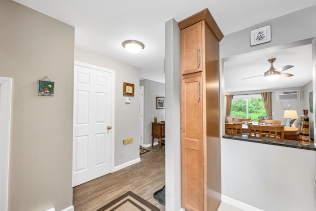 53 Evergreens Dr Unit 3, Laconia, NH 03246 - entryway with ceiling fan, light wood-style floors, and a wall unit AC