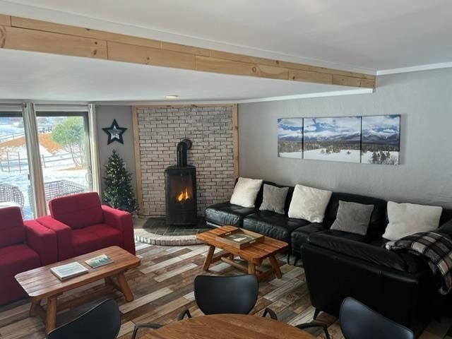 3 River Run Dr Unit A, Bartlett, NH 03812 - living area with a wood stove, crown molding, and wood finished floors