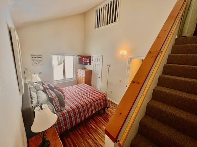 3 River Run Dr Unit A, Bartlett, NH 03812 - bedroom featuring wood finished floors and high vaulted ceiling