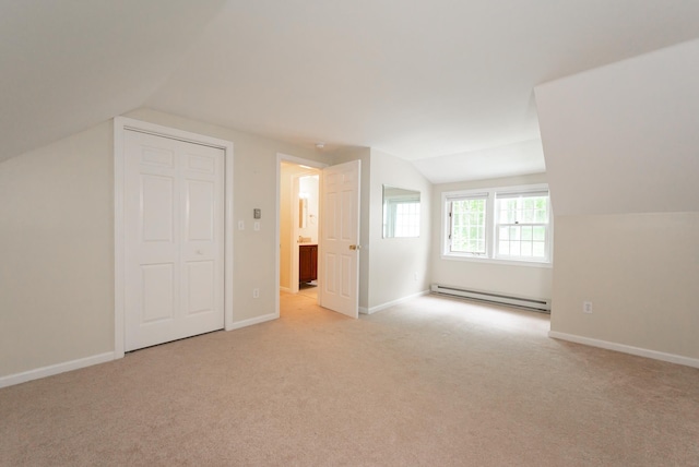 126 Flintlock Vlg Unit 3, Wells, ME 04090 - bonus room with a baseboard heating unit, lofted ceiling, and light carpet