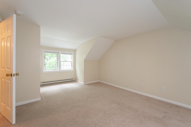 126 Flintlock Vlg Unit 3, Wells, ME 04090 - additional living space with a baseboard heating unit, vaulted ceiling, and light carpet