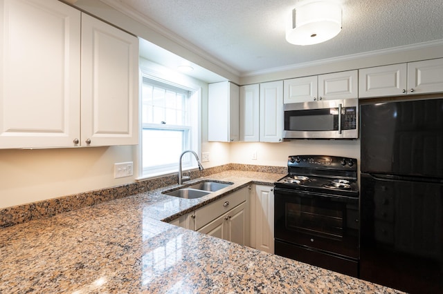 126 Flintlock Vlg Unit 3, Wells, ME 04090 - kitchen with black appliances, white cabinets, light stone counters, a textured ceiling, and crown molding