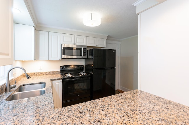 126 Flintlock Vlg Unit 3, Wells, ME 04090 - kitchen featuring black appliances, light stone countertops, white cabinetry, and ornamental molding