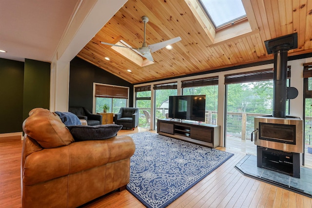 12 Water Rd, Goffstown, NH 03045 - living room with a skylight, a wood stove, wood ceiling, lofted ceiling, and hardwood / wood-style floors