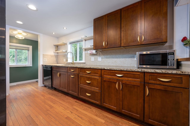 12 Water Rd, Goffstown, NH 03045 - kitchen with stainless steel microwave, dishwasher, open shelves, tasteful backsplash, and light wood-style floors
