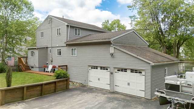 12 Water Rd, Goffstown, NH 03045 - view of property exterior with roof with shingles, a garage, a lawn, and asphalt driveway