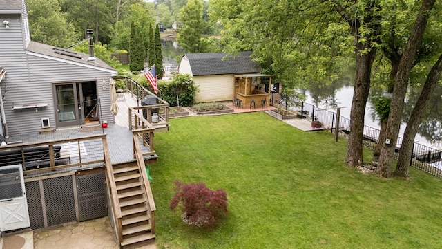 12 Water Rd, Goffstown, NH 03045 - fenced backyard with stairs, a deck with water view, and an outdoor structure