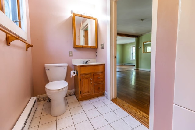 123 S Lincoln St, Keene, NH 03431 - bathroom with a baseboard radiator, vanity, and wood finished floors