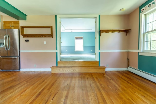 123 S Lincoln St, Keene, NH 03431 - unfurnished living room with light wood-style floors, a baseboard radiator, plenty of natural light, and rail lighting
