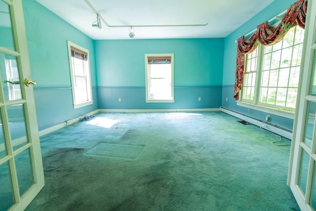 123 S Lincoln St, Keene, NH 03431 - carpeted empty room featuring a baseboard radiator and rail lighting