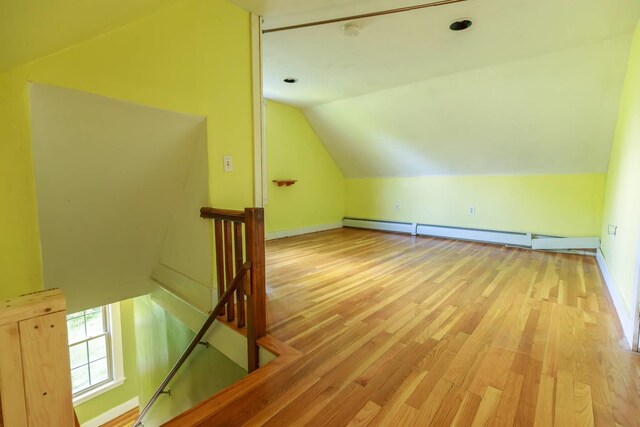 123 S Lincoln St, Keene, NH 03431 - bonus room with vaulted ceiling, a baseboard heating unit, and wood finished floors