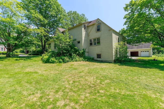 123 S Lincoln St, Keene, NH 03431 - view of home's exterior featuring a lawn and a detached garage
