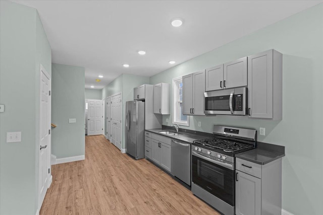 23 Ferris St Unit 102, Saint Albans City, VT 05478 - kitchen featuring stainless steel appliances, dark countertops, light wood-style flooring, gray cabinetry, and recessed lighting