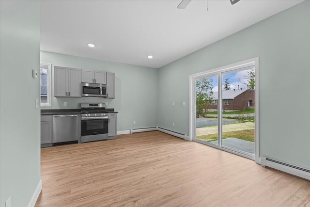 23 Ferris St Unit 102, Saint Albans City, VT 05478 - kitchen with stainless steel appliances, gray cabinetry, a baseboard heating unit, light wood-style floors, and ceiling fan