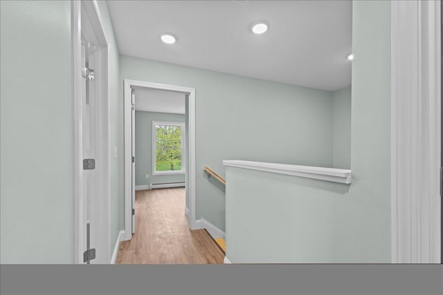 23 Ferris St Unit 102, Saint Albans City, VT 05478 - hallway with an upstairs landing, wood finished floors, a baseboard radiator, and recessed lighting