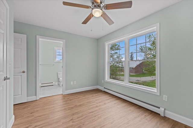 23 Ferris St Unit 102, Saint Albans City, VT 05478 - empty room with baseboard heating, plenty of natural light, and light wood finished floors