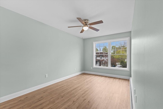 23 Ferris St Unit 102, Saint Albans City, VT 05478 - empty room with light wood finished floors, ceiling fan, and a baseboard radiator
