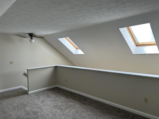 1555 Bodwell Rd Unit 59, Manchester, NH 03109 - bonus room featuring a skylight, a textured ceiling, carpet, ceiling fan, and lofted ceiling