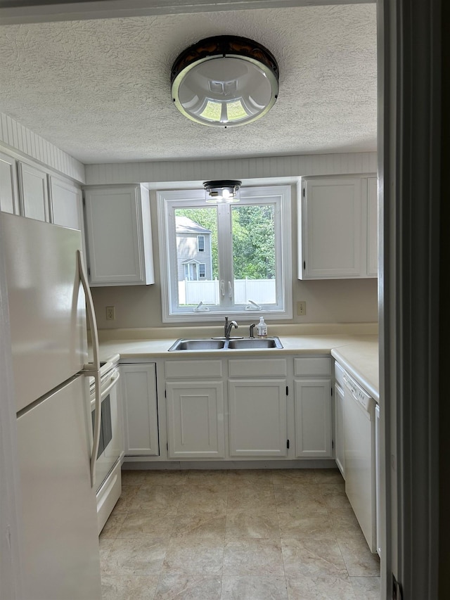 1555 Bodwell Rd Unit 59, Manchester, NH 03109 - kitchen featuring white appliances, light countertops, a textured ceiling, and white cabinets