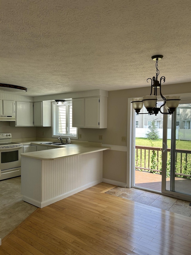 1555 Bodwell Rd Unit 59, Manchester, NH 03109 - kitchen with white electric range, under cabinet range hood, light wood-style floors, a peninsula, and white cabinets