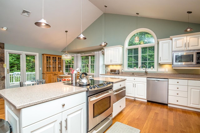 231 Grandview Rd, Conway, NH 03818 - kitchen featuring appliances with stainless steel finishes, high vaulted ceiling, light wood finished floors, decorative light fixtures, and a warming drawer