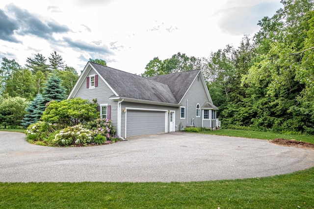 231 Grandview Rd, Conway, NH 03818 - view of side of property with asphalt driveway, an attached garage, and a shingled roof