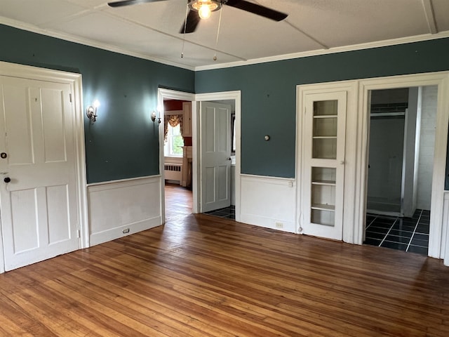 249 Ward Rd, Poultney, VT 05764 - unfurnished bedroom with radiator, wood-type flooring, crown molding, wainscoting, and ceiling fan