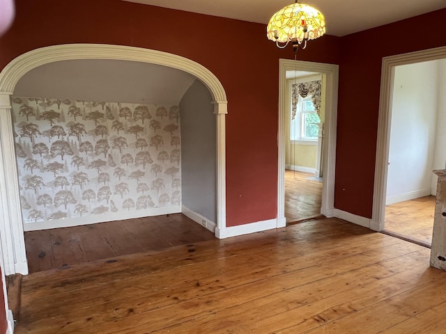 249 Ward Rd, Poultney, VT 05764 - unfurnished room featuring hardwood / wood-style floors, a chandelier, and arched walkways