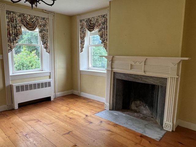 249 Ward Rd, Poultney, VT 05764 - detailed view of radiator, wood finished floors, a chandelier, and a premium fireplace