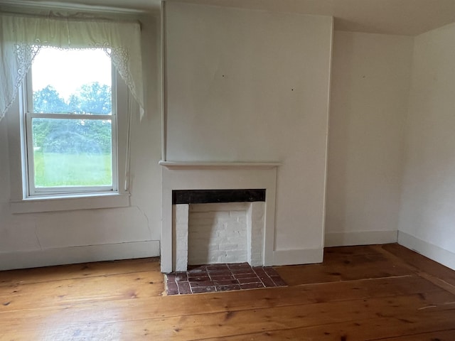 249 Ward Rd, Poultney, VT 05764 - unfurnished living room with dark wood finished floors and a fireplace with flush hearth