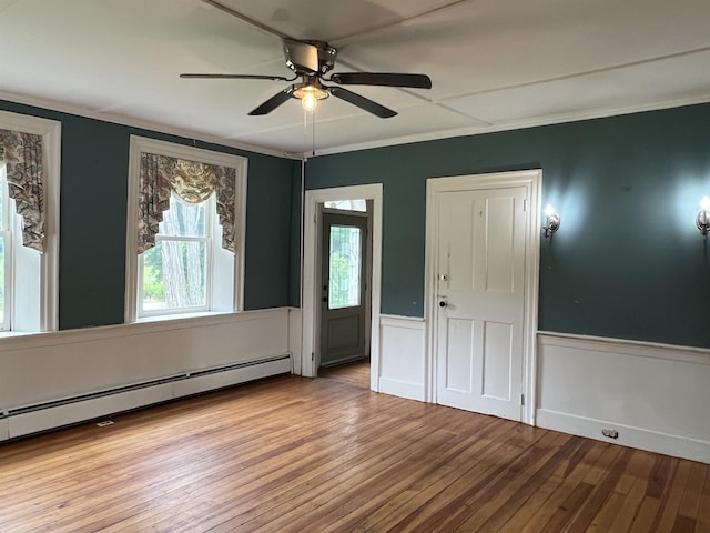 249 Ward Rd, Poultney, VT 05764 - spare room featuring hardwood / wood-style flooring, a ceiling fan, a wainscoted wall, baseboard heating, and ornamental molding
