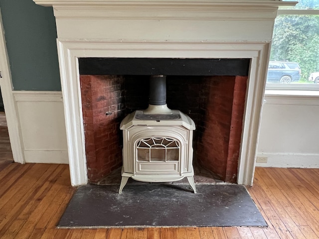 249 Ward Rd, Poultney, VT 05764 - detailed view of a wood stove, wood finished floors, and crown molding