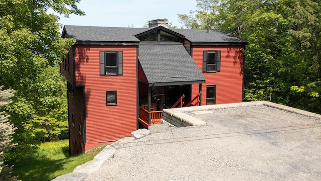 25 Benson Fuller Rd, Winhall, VT 05340 - view of front facade with a shingled roof and a chimney