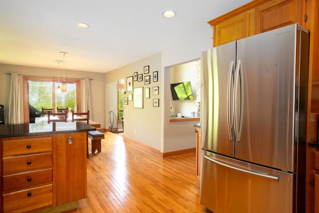 25 Benson Fuller Rd, Winhall, VT 05340 - kitchen with freestanding refrigerator, brown cabinets, light wood finished floors, recessed lighting, and pendant lighting