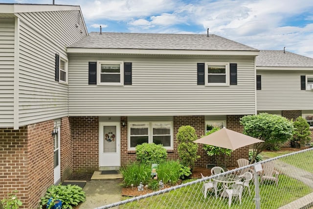 139 S Main St Unit 12, Laconia, NH 03246 - view of front of house with brick siding and roof with shingles