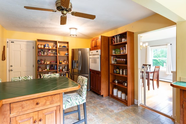 153 Mudgett Hill Rd, Loudon, NH 03307 - kitchen featuring stainless steel fridge, open shelves, white oven, tile counters, and a chandelier