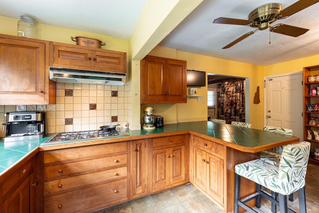 153 Mudgett Hill Rd, Loudon, NH 03307 - kitchen featuring extractor fan, a peninsula, tile counters, and backsplash