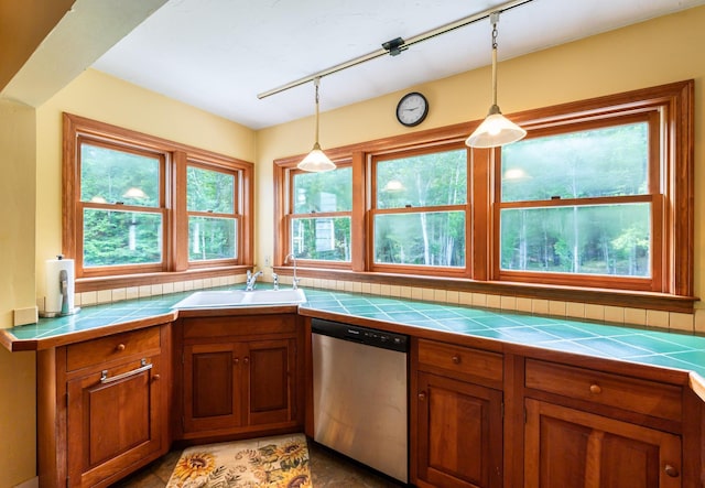 153 Mudgett Hill Rd, Loudon, NH 03307 - kitchen featuring stainless steel dishwasher, tile countertops, brown cabinetry, rail lighting, and pendant lighting