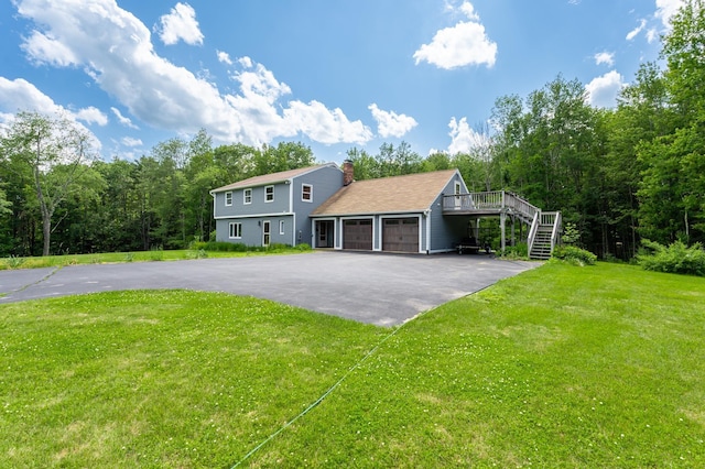 153 Mudgett Hill Rd, Loudon, NH 03307 - colonial home with driveway, stairway, an attached garage, a chimney, and a front lawn