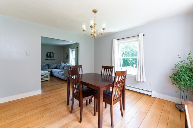 153 Mudgett Hill Rd, Loudon, NH 03307 - dining area featuring a baseboard radiator, a chandelier, and light wood-type flooring