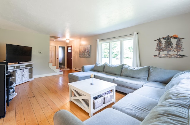 153 Mudgett Hill Rd, Loudon, NH 03307 - living area with light wood-type flooring, stairs, and a baseboard radiator