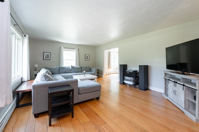 153 Mudgett Hill Rd, Loudon, NH 03307 - living room with light wood finished floors, a baseboard radiator, and a baseboard heating unit
