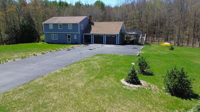 153 Mudgett Hill Rd, Loudon, NH 03307 - colonial inspired home featuring asphalt driveway, a view of trees, a front lawn, and stairs
